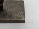 someone is using a knife to cut a piece of metal
