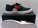 men ' s black sneakers with red, white and blue stripes on the sole