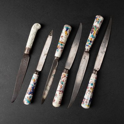 six different types of knives are lined up on a black surface