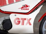 a red and white motorcycle parked on the side of the road