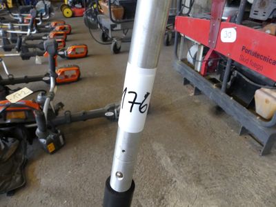 a pole with a sticker on it in a warehouse