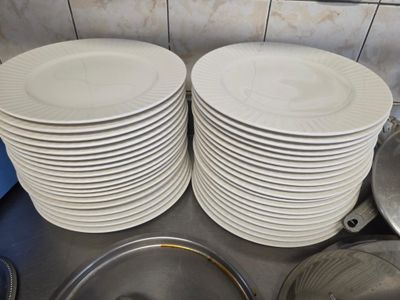 many plates stacked on top of each other on the kitchen counter