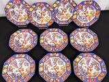 six blue and orange plates with floral designs on them on a table