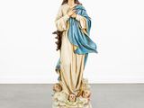 the statue of the virgin mary is holding a baby jesus in her arms
