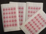 three red and white stamps with a picture of a woman on them