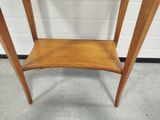 a small wooden table with a shelf on it