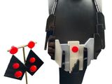 a black mannequin with red buttons and a gold stand