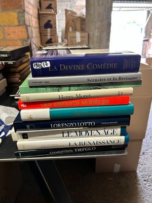 several books are stacked on top of each other on a table