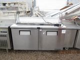 a kitchen that has a sink and a refrigerator in it