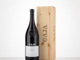 a bottle of wine sitting next to a wooden box