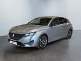 a silver car is parked in a room with a white wall
