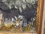 une peinture à l'huile d'un paysage urbain dans un cadre doré sur un mur