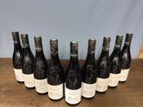 six bottles of wine are lined up in a row on a table