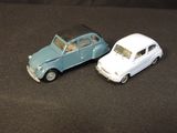 two toy cars that are sitting next to each other on a table