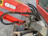 a close up of a red tractor with a sign on the back of it