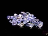 some very pretty purple and white diamonds on a black surface