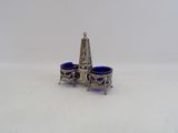 two blue glass cups sitting on top of a silver plate