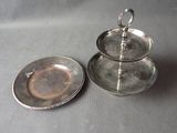 silver plate with three tiered trays sitting on top of a table