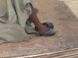 a painting of a woman ' s feet and shoes on the ground