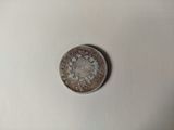 a small coin with a picture of a man on it