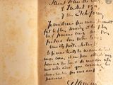 an old book with writing on it sitting on a table