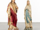 two statues of jesus and mary are standing next to each other