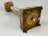 a wooden object that is sitting on a white surface