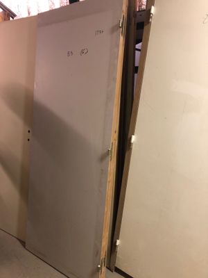 a refrigerator that is in the corner of a room