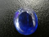 une boule de verre bleue posée sur une surface noire