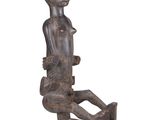 an image of a statue of a person sitting on a table