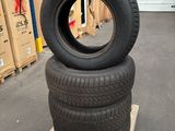 tires stacked on pallets in a warehouse with boxes in the background