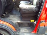 a red car with a suitcase in the back of it
