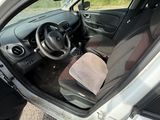 the interior of a car with the door open and the driver ' s seat down