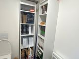 a bathroom with a toilet and a book shelf in it
