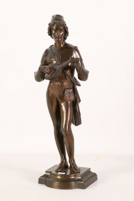 an antique bronze statue of a woman holding a basket