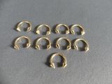 a bunch of gold rings sitting on top of a table