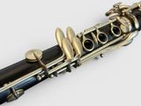 a close up of a black and gold clarinet