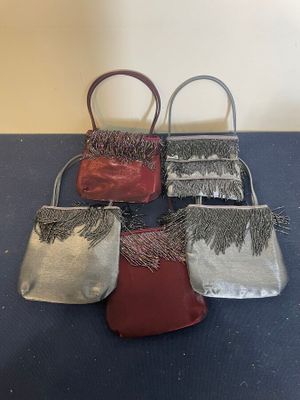 four small purses are lined up on a blue surface