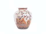 a white vase with a floral design on it