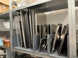 many pans and pans on the shelves in the kitchen