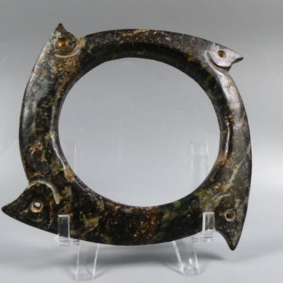 sculpture of a fish on a stand with a mirror in the background