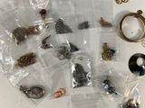 a lot of jewelry sitting on a table next to a blue bowl