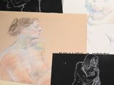 several different colored drawings of a man and a woman on a table