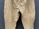 an old pair of pants hanging on a clothes line on a wall