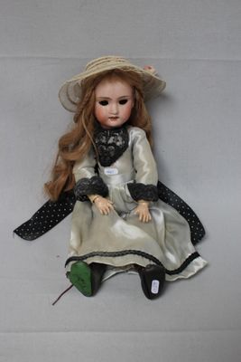 a doll that is sitting on the floor with a hat on