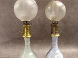 paire de lampes anciennes en verre sur des pieds en laiton, avec des globes en verre dépoli