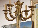 a gold chandelier hanging from a ceiling in a room