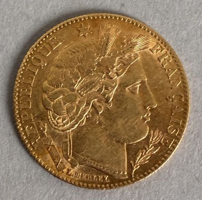 a close up of a gold coin with a woman ' s head on it