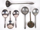 several spoons and spoon spoons are lined up on a white surface