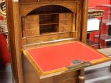 a wooden desk with a red top in a room with red walls